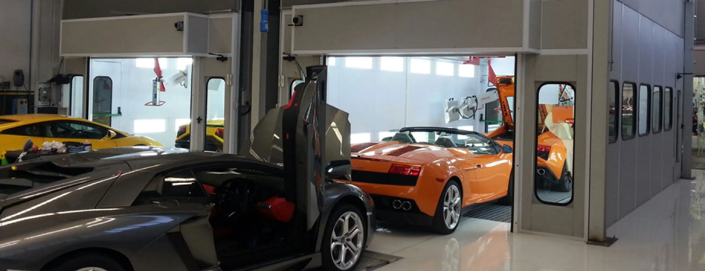 Luxury cars inside a paint booth